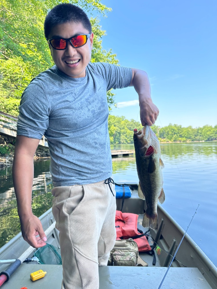 Andy holding a fish during a day on the lake